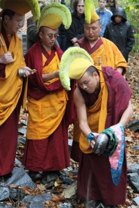 Monks pour the sand from the mandala into the closest body of water - a stream behind the Randolph College campus which flows into the James River.