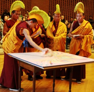 Monks sweep away the sand of the mandala created at Randolph College.