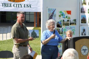 Marge Denham speaks about the deodar cedar tree at Randolph College, named the 2013 Heritage Tree, as Mark Gilbert shows a photo of the tree