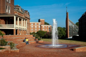 Two students watch the sun rise in Michels Plaza outside the Randolph College student center.