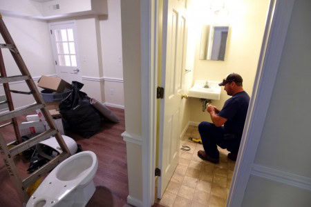 Buildings and Grounds staff member adds finishing touches to new apartments. (Photo courtesy of The News & Advance.