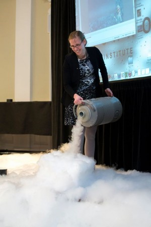 Physicist Rebecca Thompson uses liquid nitrogen during her talk about the physics in the movie "Frozen" on Thursday evening.