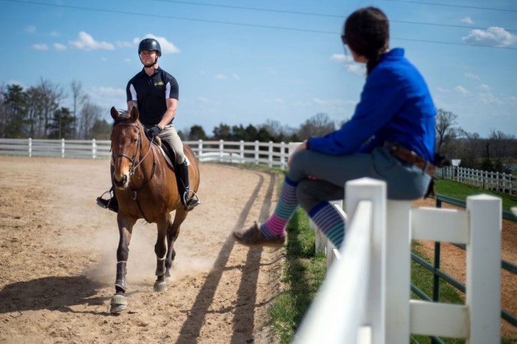Michael Ramsey, a Navy veteran and member of the equestrian team at Randolph College, is coached by Margaret Swanson during a training session last week at the Randolph College Riding Center. (Photo by Max Oden/The News & Advance)