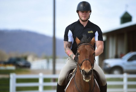 Michael Ramsey, a Navy veteran and member of the equestrian team at Randolph College, rides Koen during a training session at the Randolph College Riding Center. 