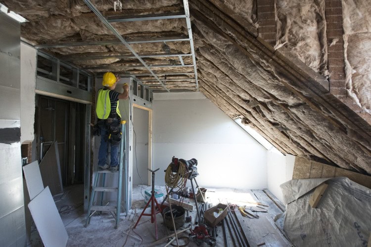 A worker frames new walls in a Wright Hall room that was completely remodeled.