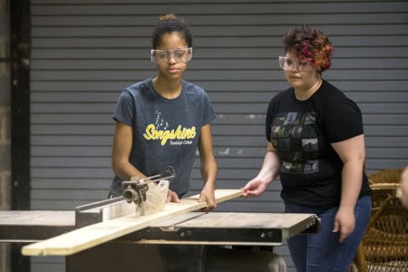 Morgan Wardlaw ’17 (left) and Daisy Howard ’17 rip a board for a small set that will be used to demonstrate their stage illusions.