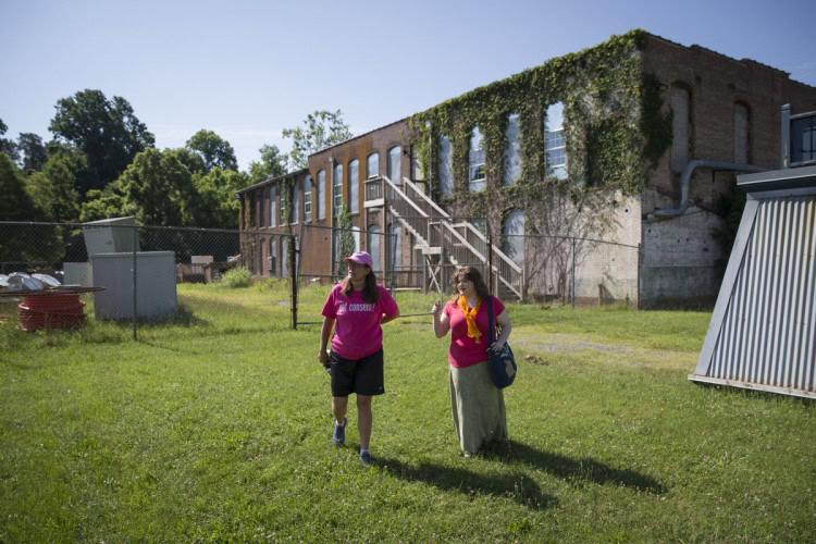 Danielle Currier (left) and Ayla Hagen '18 visit the site of a Lynchburg mill that closed in the 1950s.