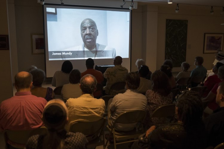 People attend a reception for a new exhibit at the Maier Museum of Art at Randolph College