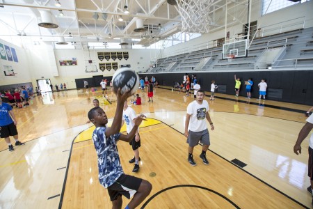 A camper goes in for a layup while Evan Horn '16 (right) looks on.