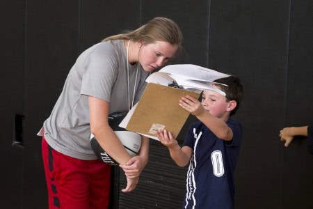 Brie Holdren '17 goes over notes with a camper.