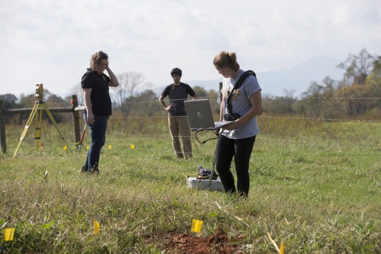 Sara Woodward '16 pulls the GPR device across the site while Sarah Sojka and Hagay Haut '16 observe.