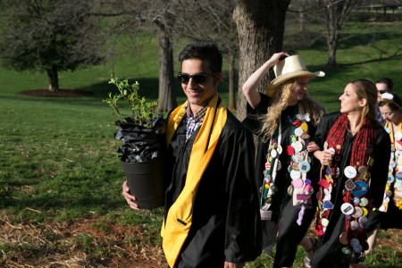 Sandeep Poudyal '16 and his classmates process across front campus to plant rose bushes along the Red Brick Wall.