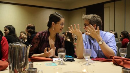 Lindsay Brents '16 reacts with English professor Gary Dop after winning an award for best fiction piece at the recent Sigma Tau Delta International Conference.