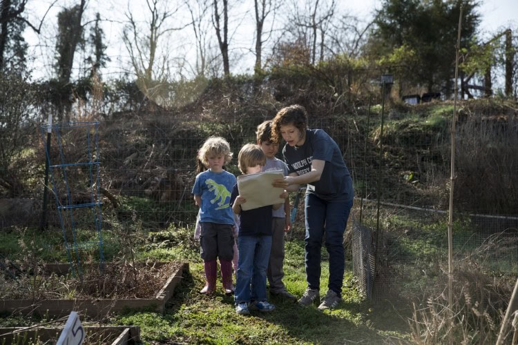 Instructor Shanna Jackson helps RCNS students find their gardens using a map. Instructor Shanna Jackson helps RCNS students find their gardens using a map.