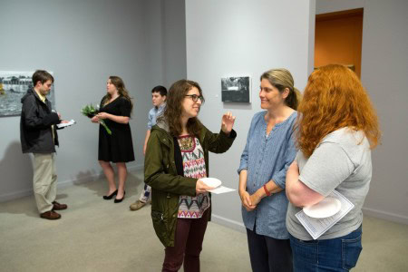 Friends and colleagues visit at Andrea Mewhinney's Senior Art Exhibit reception.