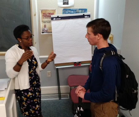 Tia Stokes-Brown ’97 discusses politics and her research with a Randolph student following her presentation Thursday.