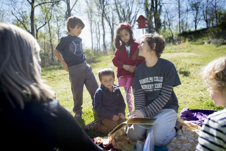 Teacher Shanna Jackson reads a book about praying mantises to the students of Randolph College Nursery School on Wednesday while in the organic garden on campus at Randolph College. Photo by Jill Nance