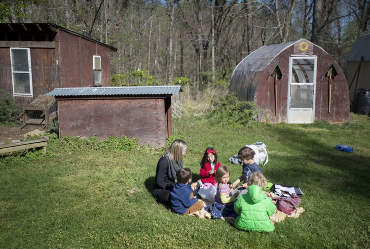 Students in the "5K" program at Randolph College Nursery School spend their morning outside in the organic garden on Wednesday. Photo by Jill Nance