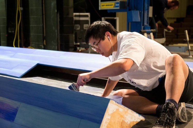 Sam Sun '17 paints part of the set for Hank Williams: Lost Highway, which will be performed in Thoresen Theatre later this year.