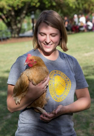 Sara Woodward '16 holds a chicken at last year's Involvement Fair.