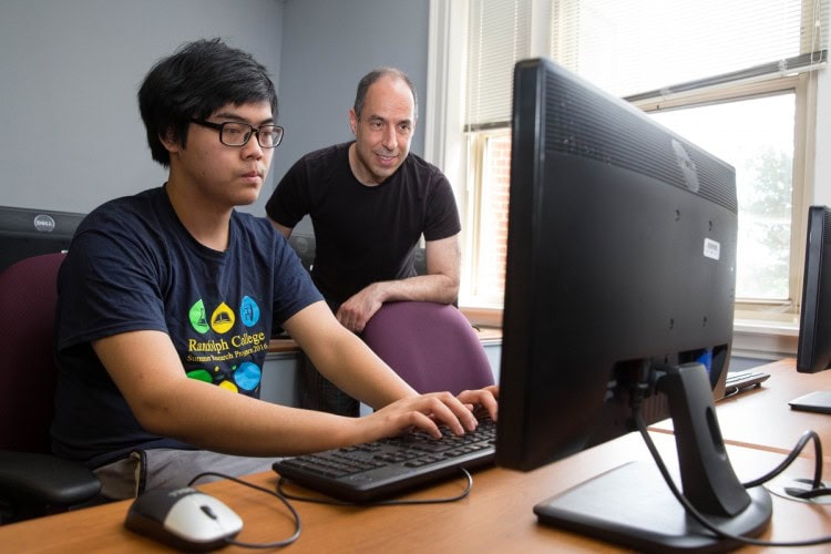 Anh Vo '18 and mathematics professor Marc Ordower play John Conway's Game of Life.