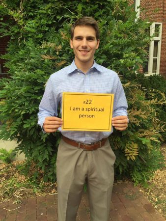 Brian Crosby '16, assistant men's lacrosse coach, holds a sign that represents him.