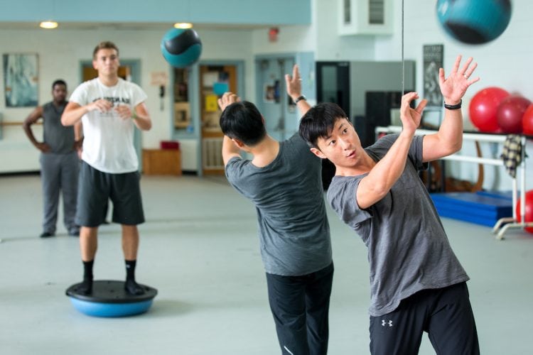 Visiting dance professor Seyong Kim works out with students in Men's Movement class.