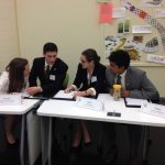 Members of the 2016 Ethics Bowl team discuss their answer to a question. Members of the 2016 Ethics Bowl team discuss their answer to a question.