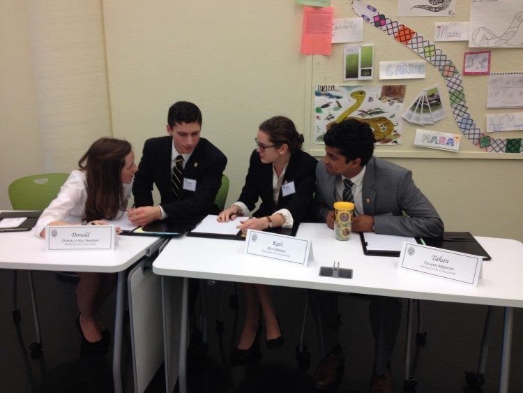 Members of the 2016 Ethics Bowl team discuss their answer to a question. Members of the 2016 Ethics Bowl team discuss their answer to a question.