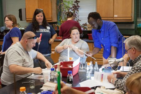 Igor Ngabo '18 assists teachers in an activity during Randolph's 2017 teaching institute, "Teaching Math and Science in a Changing World."