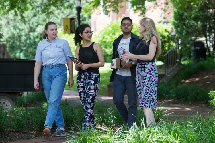 (From left) Sustainability coordinator Sara Woodward '16, Shataaxi Joshi '19, Arnav Upadhyay '19, and the Herzog Family Chair of Environmental Studies Karin Warren discuss their project while walking on campus.