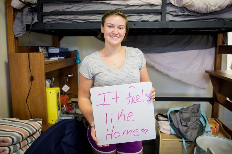 Student holding sign