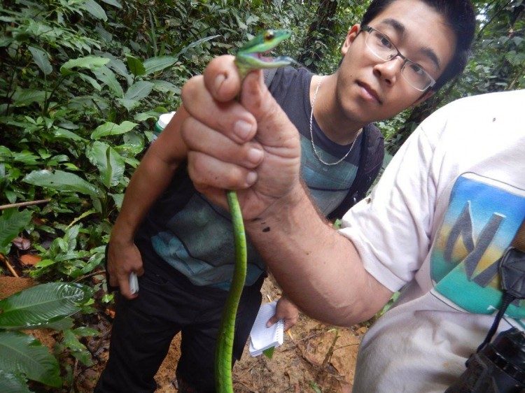 Student handling snake