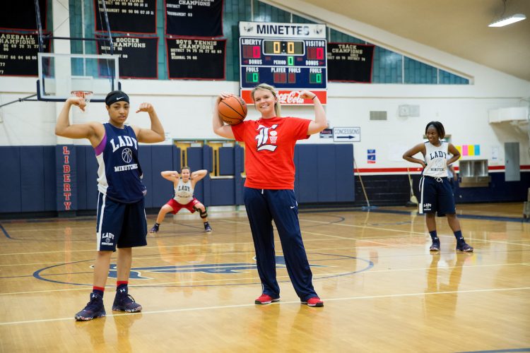 Emilee Dunton '14, '15 M.A.T. strikes a pose with her players during practice.