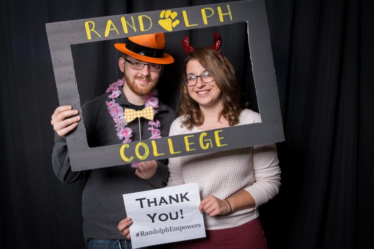Students pose in the Giving Tuesday photo booth, holding thank you signs. Students pose in the Giving Tuesday photo booth, holding thank you signs.