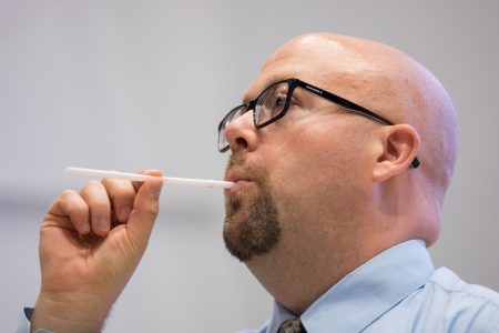 Nicholas Perna leads students on a vocal exercise using straws.