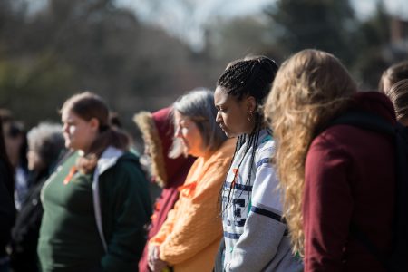 Close-up of students meditating/praying in the crowd