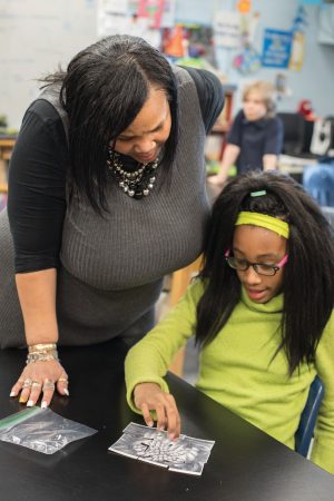 Tawanda Johnson '90 works with a student in Dearington Elementary's Curiosity Club