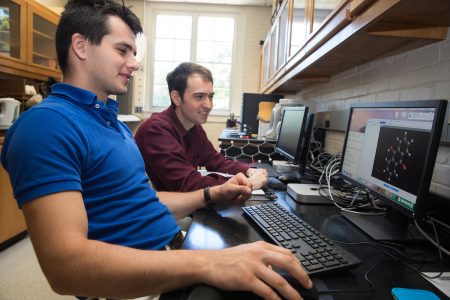 Yuriy Snyder '19 (left) and chemistry professor Jesse Kern test a molecule using computational modeling software