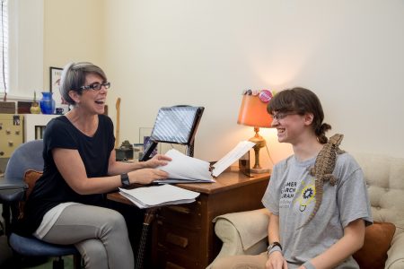 English professor Laura-Gray Street, Celina Matthews '19, and Elsker look through some of the submitted poetry and artwork for their project.