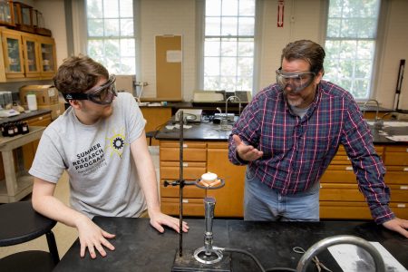 Matthew Williams '20 (left) and chemistry professor Bill Bare experiment on phosphoric material in the chemistry lab