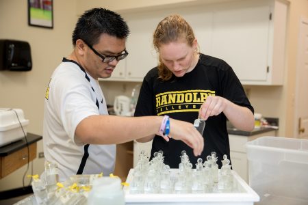 Bill Pham '20 and Margaret Van Beek '19 test water samples in the environmental lab.