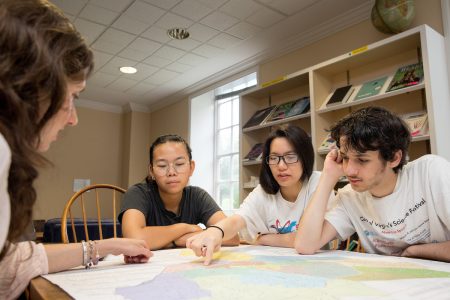 Professor Liz Perry-Sizemore, San Hoang '20, Anh “Jessica” Bui ’20, and Leo Cohen look at a map of Lynchburg.