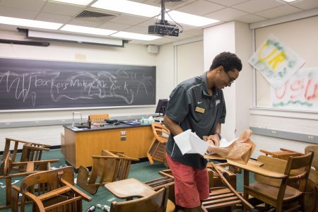 Josh Yeast '19 prepares the "Crime Scene Investigation" activity, which involved a vandalized classroom.