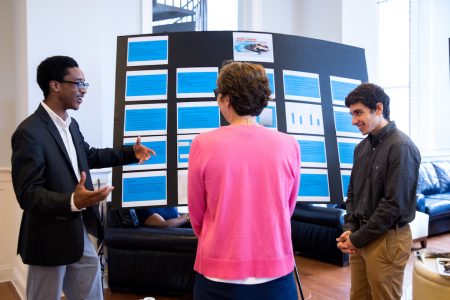 Josh Yeast '19 (left) and Damien Douglas present a poster about the project, "Teaching Math and Science in a Changing World."