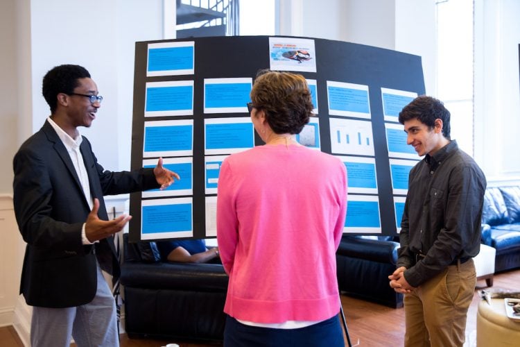Josh Yeast '19 (left) and Damien Douglas present a poster about the project, Josh Yeast '19 (left) and Damien Douglas present a poster about the project,