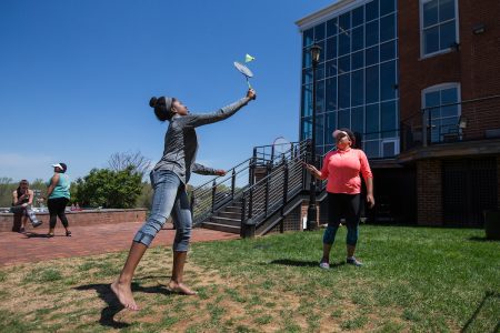 Taylor Samuels ’18 (left) and Stacey Samuels ’18 play badminton during Macon Activities Council's Outdoor Fest in April.