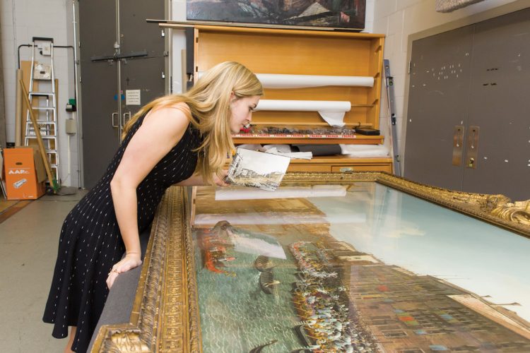 Elisabeth Price ’16 examines a painting in the vault