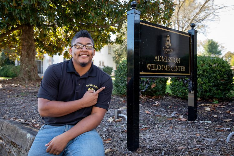 Corey Brown '16 in front of Randolph's Admission Welcome Center