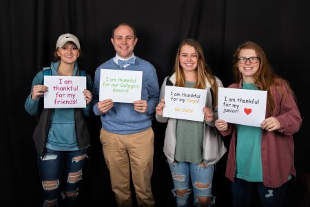 Wes Fugate, vice president for student affairs, and Randolph students express their gratitude at the Giving Tuesday photo booth